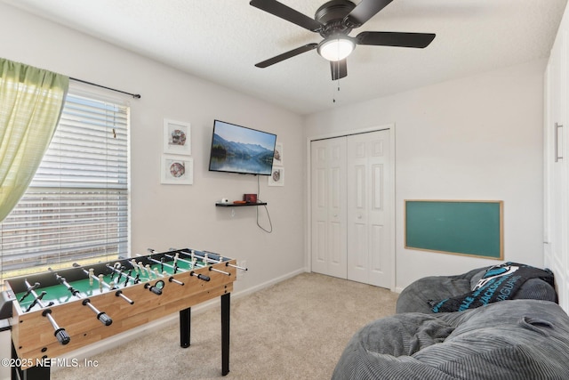 game room featuring ceiling fan and light colored carpet