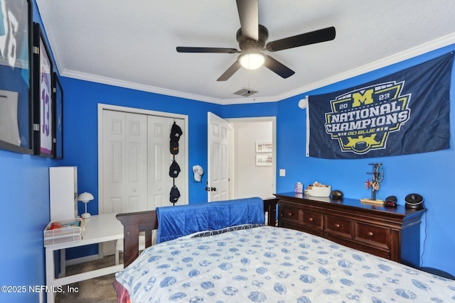 carpeted bedroom featuring crown molding, ceiling fan, and a closet