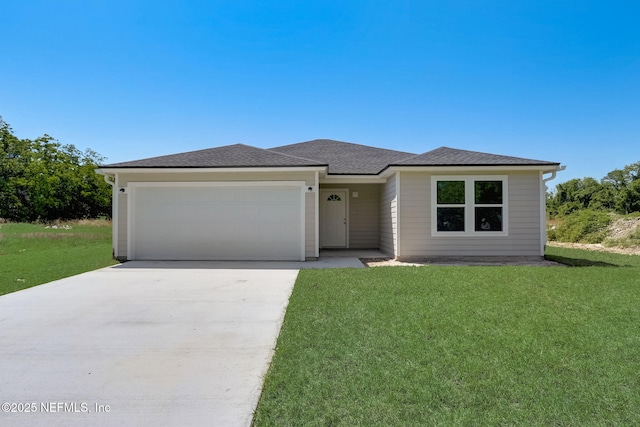 view of front facade with a garage and a front yard