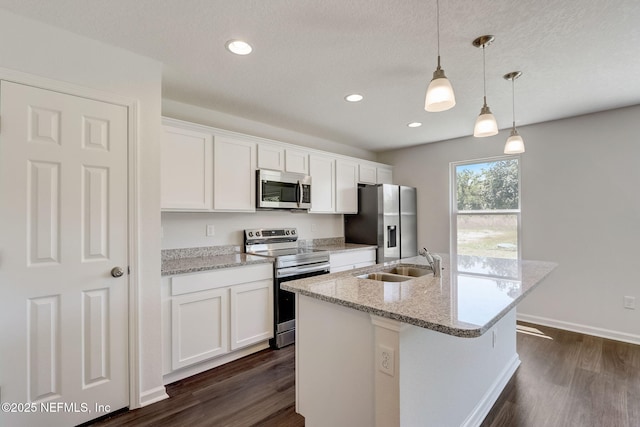 kitchen with white cabinetry, appliances with stainless steel finishes, sink, and hanging light fixtures