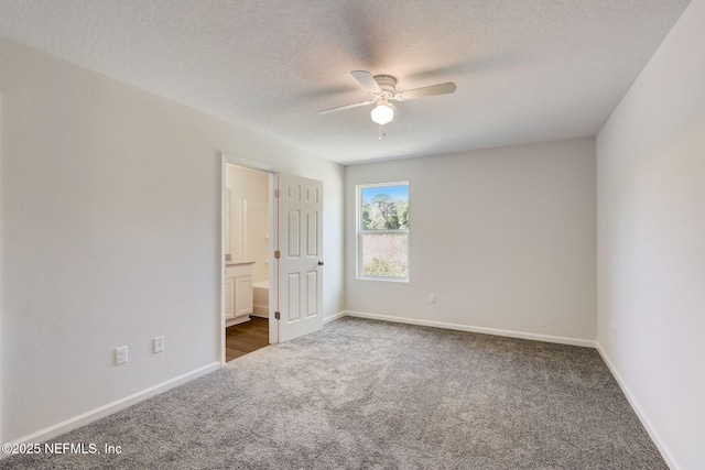 carpeted spare room with ceiling fan and a textured ceiling