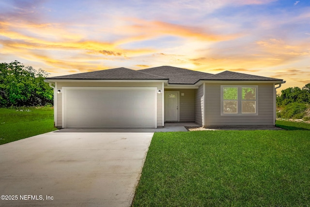 prairie-style home with a garage and a lawn