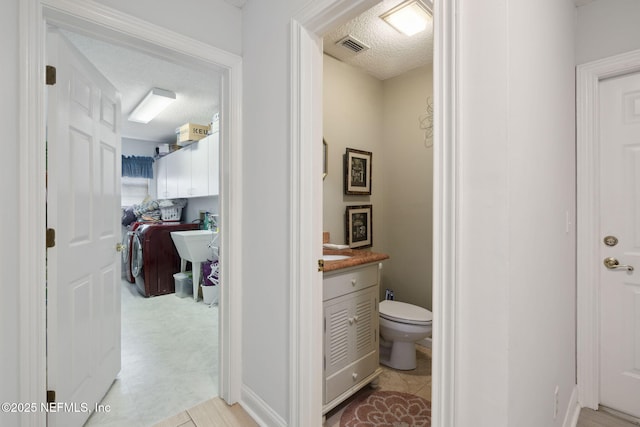 744 Cherry Grove Rd, Orange Park, FL 32073 - bathroom featuring vanity, toilet, and a textured ceiling