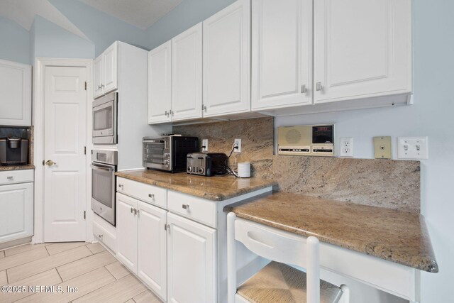 744 Cherry Grove Rd, Orange Park, FL 32073 - kitchen featuring white cabinetry, stone countertops, and appliances with stainless steel finishes