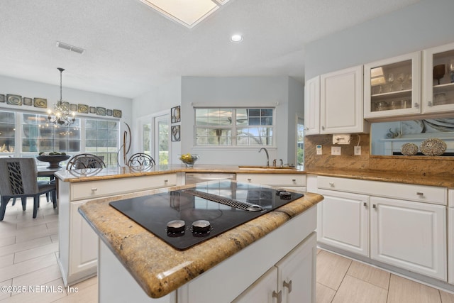 744 Cherry Grove Rd, Orange Park, FL 32073 - kitchen featuring white cabinetry, pendant lighting, a center island, and black electric stovetop