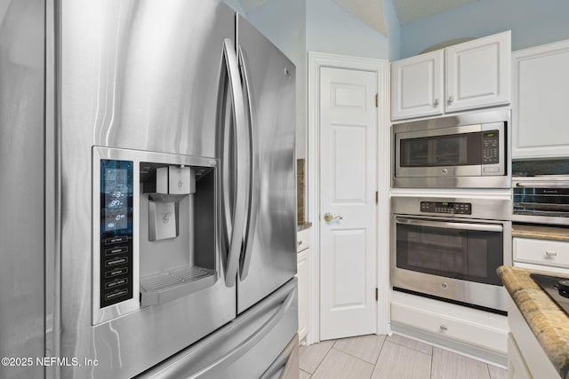 744 Cherry Grove Rd, Orange Park, FL 32073 - kitchen with white cabinetry, appliances with stainless steel finishes, and light stone countertops