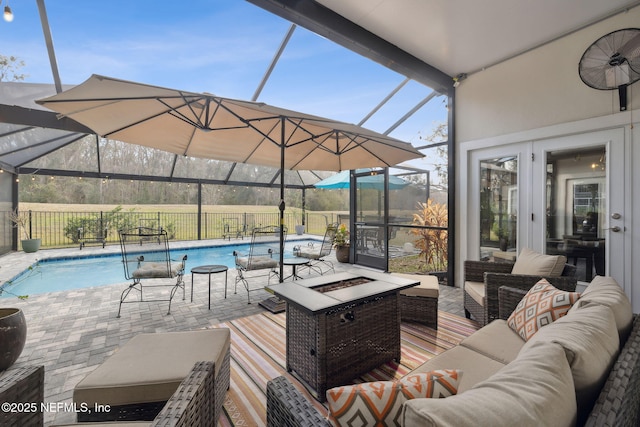 744 Cherry Grove Rd, Orange Park, FL 32073 - view of patio featuring a fenced in pool, a lanai, an outdoor living space with a fire pit, and french doors