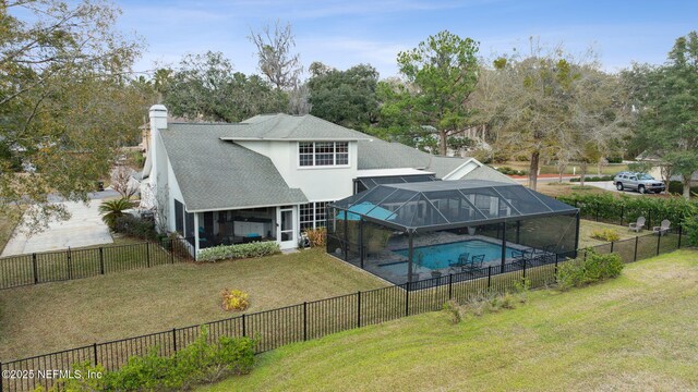 744 Cherry Grove Rd, Orange Park, FL 32073 - back of house with a fenced in pool, glass enclosure, and a lawn