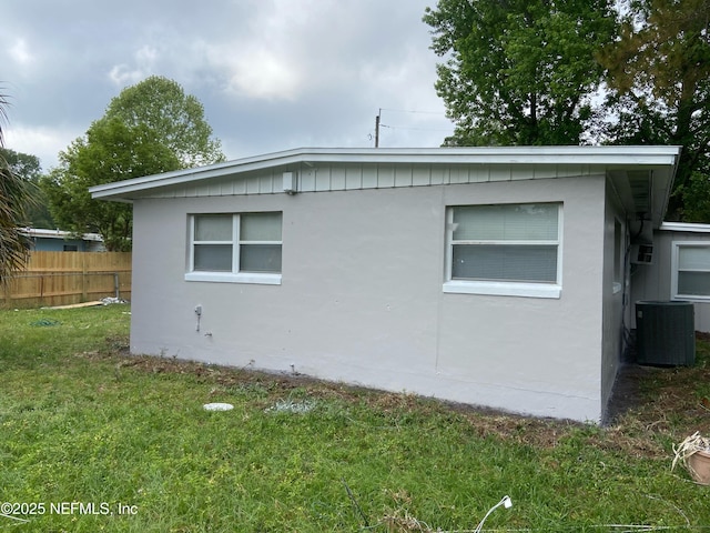 view of home's exterior with a yard and central AC unit