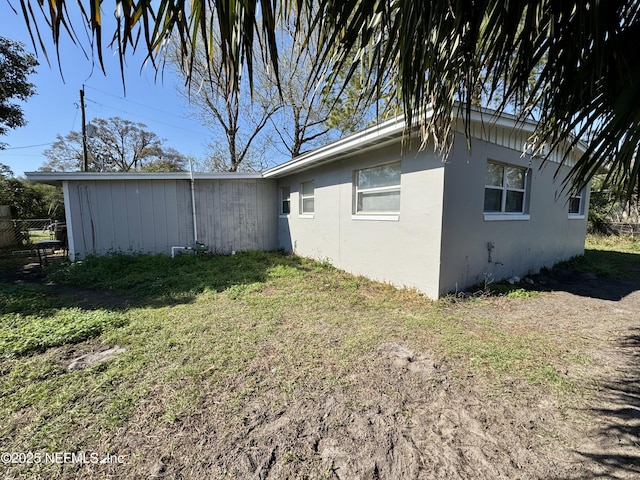 view of property exterior featuring a yard and stucco siding