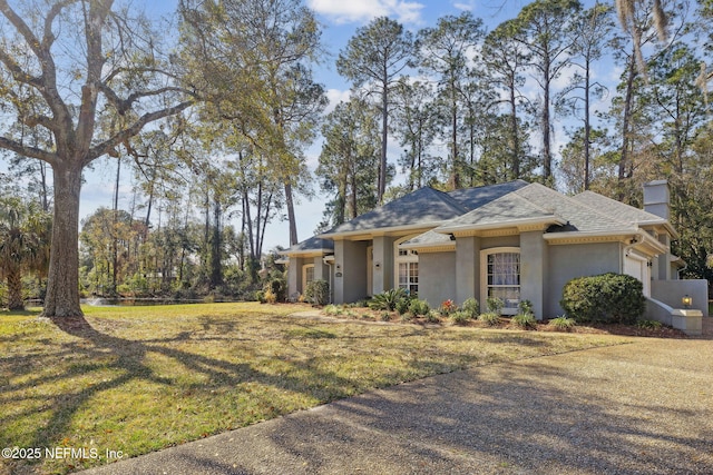 view of front facade with a garage and a front lawn