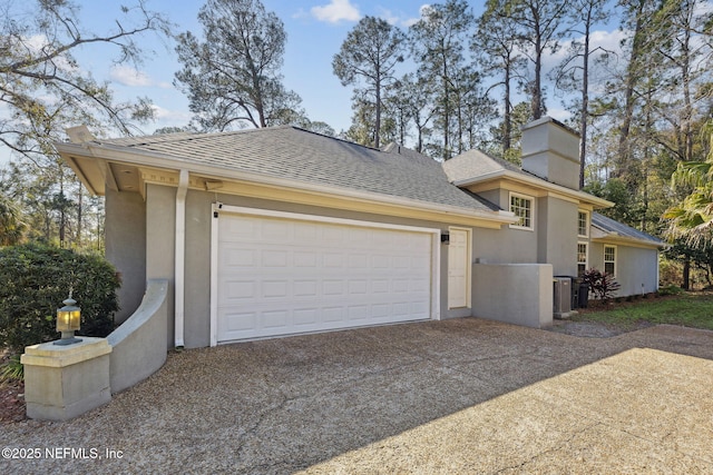 exterior space with a garage and central AC unit