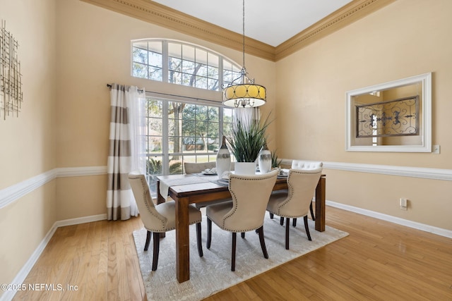 dining room featuring hardwood / wood-style flooring and ornamental molding