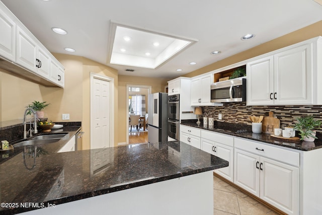 kitchen featuring sink, stainless steel appliances, and white cabinets