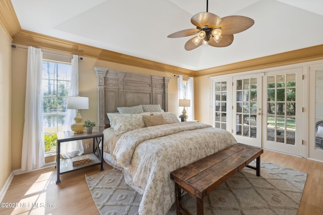 bedroom with french doors, vaulted ceiling, access to outside, and light hardwood / wood-style flooring