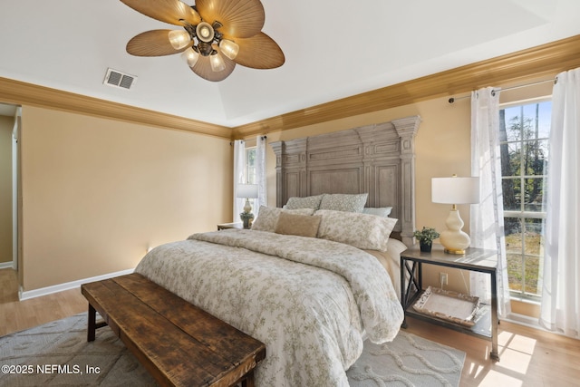 bedroom with vaulted ceiling, hardwood / wood-style floors, and ceiling fan