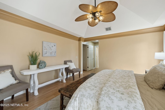 bedroom with hardwood / wood-style flooring, vaulted ceiling, and ceiling fan