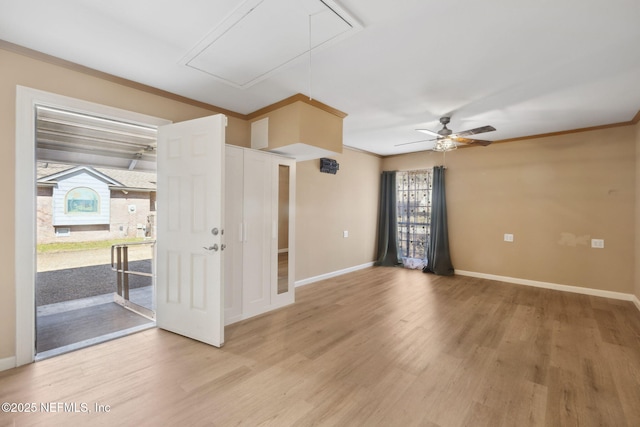 spare room featuring crown molding, ceiling fan, and light wood-type flooring