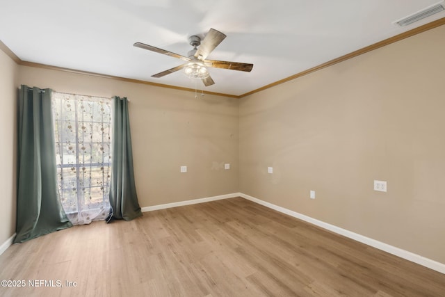 unfurnished room featuring ornamental molding, ceiling fan, and light wood-type flooring