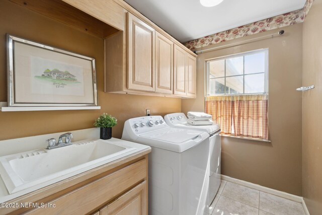 washroom featuring cabinets, sink, light tile patterned floors, and independent washer and dryer