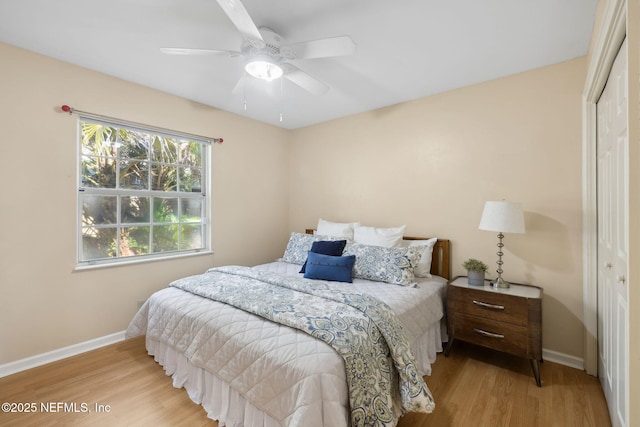 bedroom with light hardwood / wood-style floors, a closet, and ceiling fan