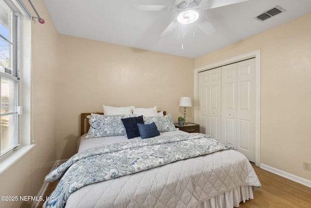 bedroom featuring wood-type flooring, a closet, and ceiling fan