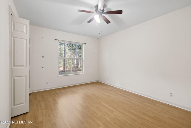 empty room with ceiling fan and light wood-type flooring