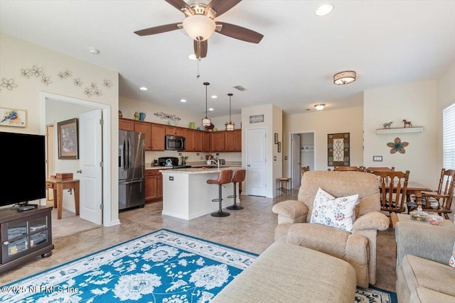 tiled living room with sink and ceiling fan