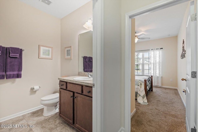 bathroom featuring ceiling fan, vanity, and toilet