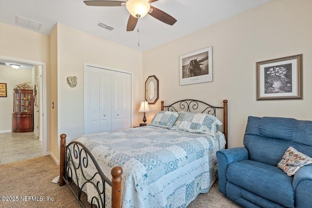 carpeted bedroom with ceiling fan and a closet