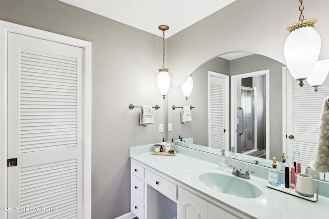 full bathroom with a shower stall and vanity