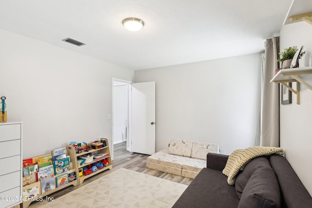 interior space with visible vents and wood finished floors