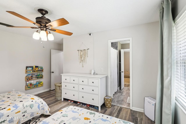 bedroom with ceiling fan, baseboards, and wood finished floors