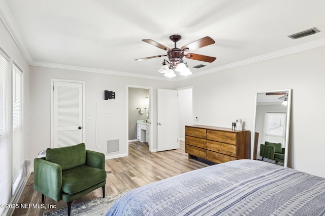 bedroom with ornamental molding, wood finished floors, and visible vents