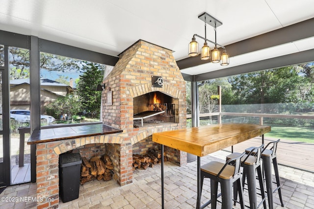 interior space featuring an outdoor brick fireplace and plenty of natural light