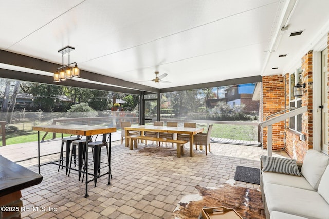 sunroom / solarium with visible vents and ceiling fan