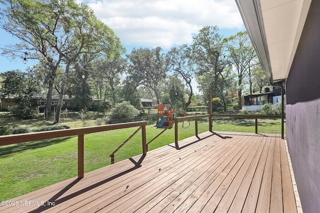 wooden terrace featuring a yard and a playground