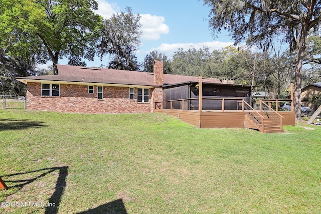 rear view of property with a sunroom, a chimney, stairs, fence, and a yard