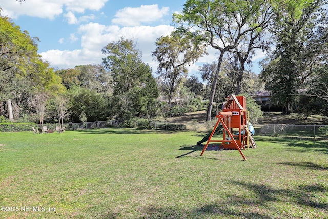 view of yard featuring a playground and fence