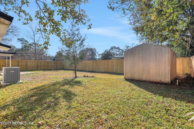 view of yard featuring a shed and central air condition unit