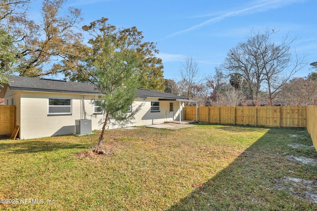 back of property featuring cooling unit, a patio, and a lawn