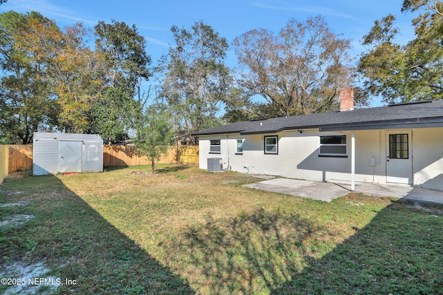 rear view of house featuring central AC, a storage unit, a patio, and a lawn