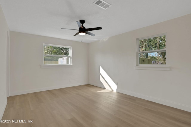 spare room featuring light hardwood / wood-style flooring and ceiling fan