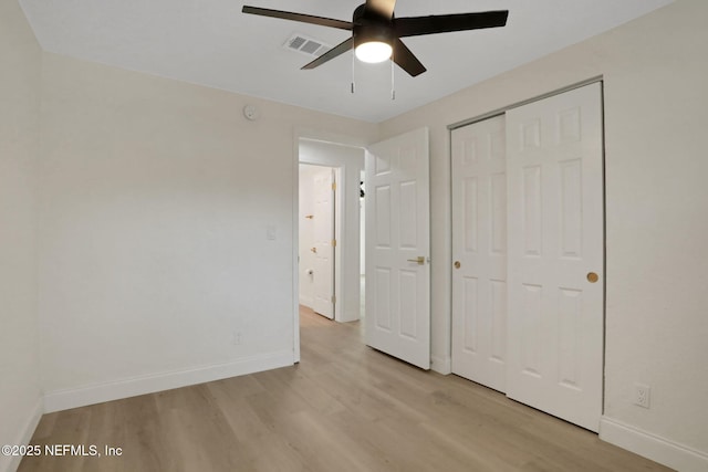 unfurnished bedroom with light hardwood / wood-style floors, a closet, and ceiling fan