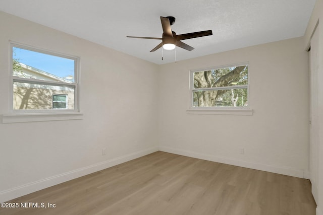 spare room with ceiling fan and light hardwood / wood-style flooring