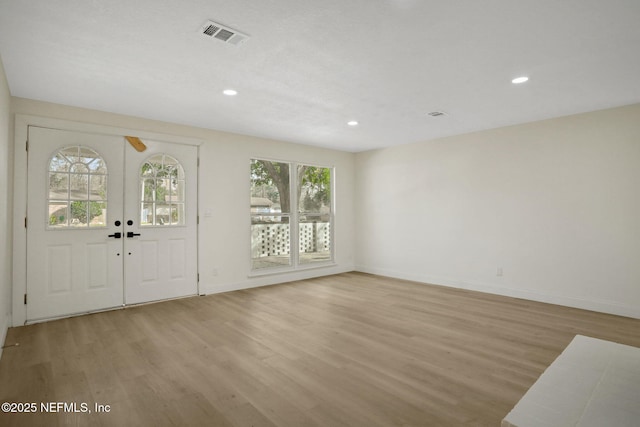 entrance foyer with french doors and light wood-type flooring