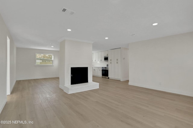 unfurnished living room with light hardwood / wood-style flooring