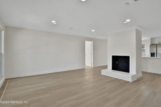 unfurnished living room with light wood-type flooring