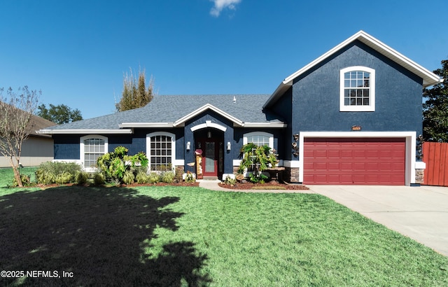 view of front of property featuring a garage and a front lawn