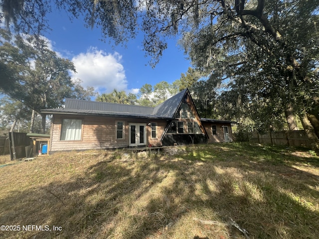 rear view of property with a yard and french doors